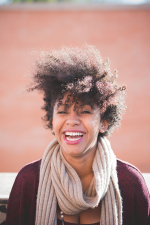 beautiful black curly hair african woman in townの写真素材