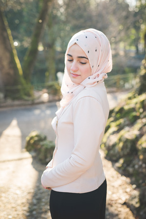 young beautiful muslim woman at the park in springの写真素材
