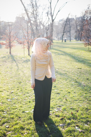 young beautiful muslim woman at the park in springの写真素材