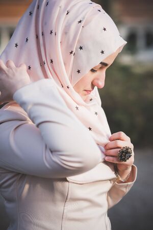 young beautiful muslim woman at the park in springの写真素材