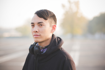 young crazy funny asian man in town outdoor lifestyleの写真素材