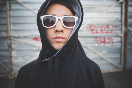 young asian hip hop man in town outdoor lifestyleの写真素材
