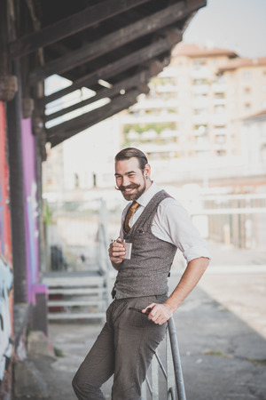handsome big moustache hipster man smoking pipe in the cityの写真素材