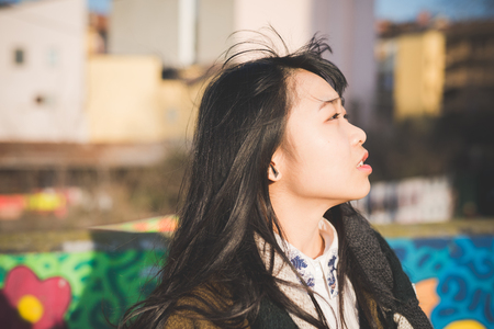 young beautiful asian hipster woman in the cityの写真素材