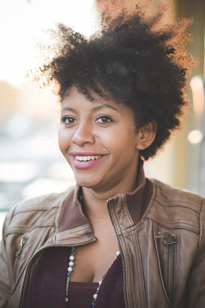 beautiful black curly hair african woman in townの写真素材