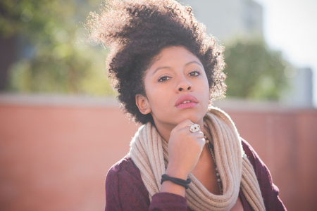 beautiful black curly hair african woman in townの写真素材