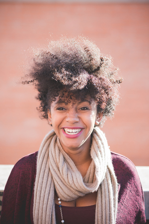 beautiful black curly hair african woman in townの写真素材