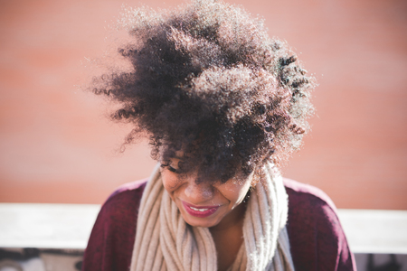 beautiful black curly hair african woman in townの写真素材