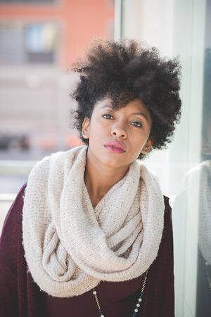 beautiful black curly hair african woman in townの写真素材