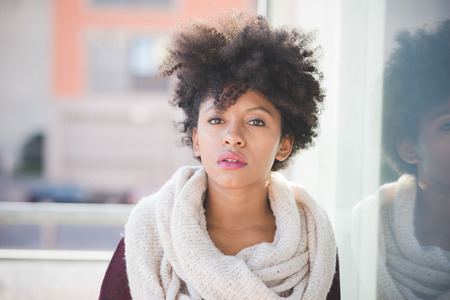 beautiful black curly hair african woman in townの写真素材
