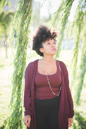beautiful black curly hair african woman in townの写真素材