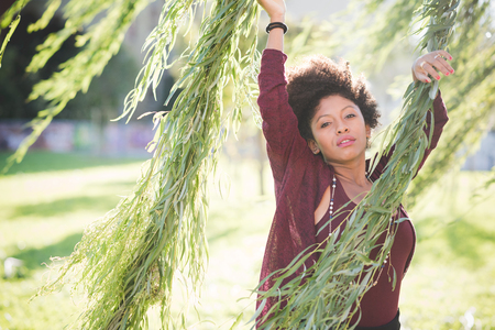 beautiful black curly hair african woman in townの写真素材