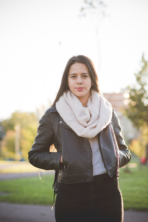 young beautiful long hair woman in town during sunset backlightの写真素材