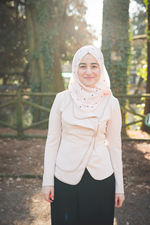 young beautiful muslim woman at the park in springの写真素材