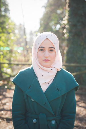 young beautiful muslim woman at the park in springの写真素材