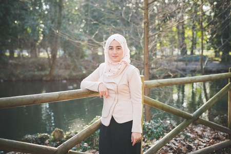 young beautiful muslim woman at the park in springの写真素材