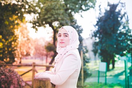 young beautiful muslim woman at the park in springの写真素材