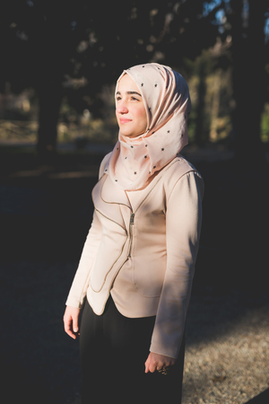 young beautiful muslim woman at the park in springの写真素材