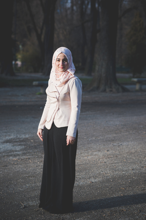 young beautiful muslim woman at the park in springの写真素材