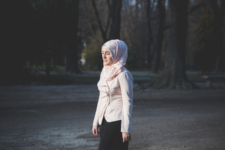 young beautiful muslim woman at the park in springの写真素材