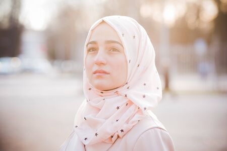 young beautiful muslim woman at the park in springの写真素材
