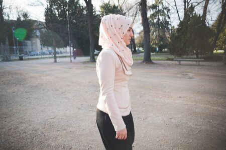 young beautiful muslim woman at the park in springの写真素材