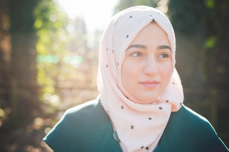 young beautiful muslim woman at the park in springの写真素材