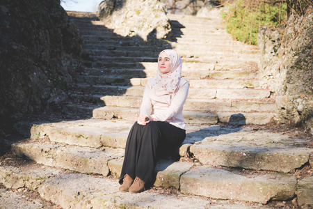 young beautiful muslim woman at the park in springの写真素材