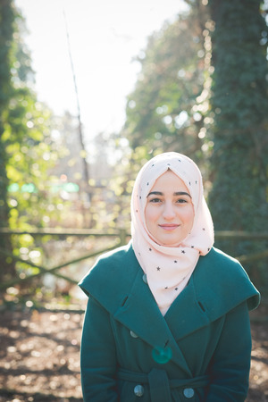 young beautiful muslim woman at the park in springの写真素材