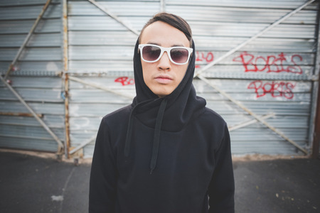young asian hip hop man in town outdoor lifestyleの写真素材