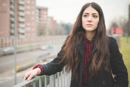 young beautiful long hair model woman living the city in winter outdoor cityの写真素材