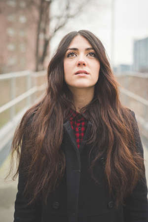 young beautiful long hair model woman living the city in winter outdoor cityの写真素材