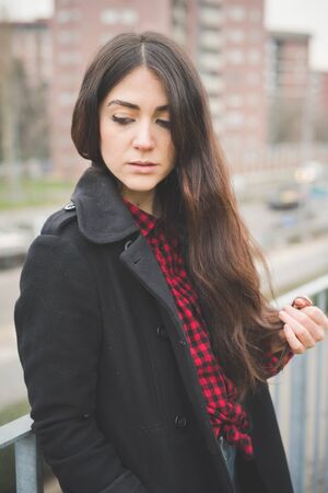 young beautiful long hair model woman living the city in winter outdoor cityの写真素材