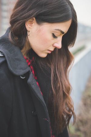 young beautiful long hair model woman living the city in winter outdoor cityの写真素材
