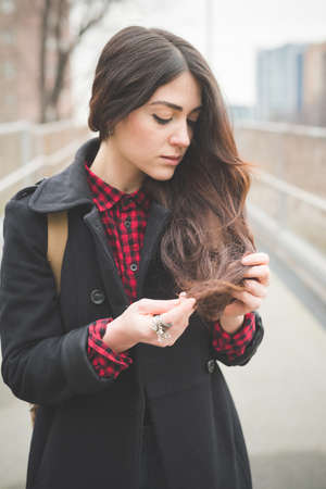 young beautiful long hair model woman living the city in winter outdoor cityの写真素材