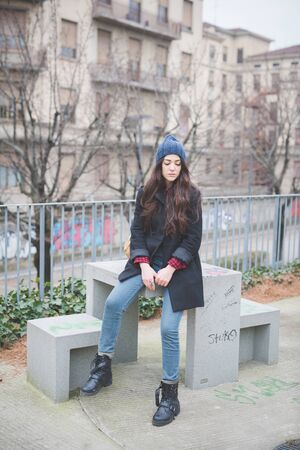 young beautiful long hair model woman living the city in winter outdoor cityの写真素材