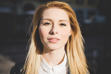 young beautiful blonde straight hair woman in the cityの写真素材
