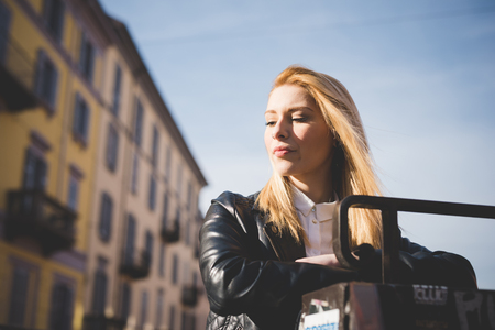 young beautiful blonde straight hair woman in the cityの写真素材