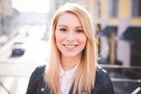young beautiful blonde straight hair woman in the cityの写真素材