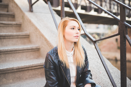 young beautiful blonde straight hair woman in the cityの写真素材