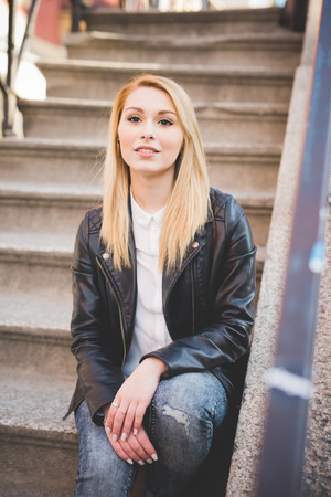 young beautiful blonde straight hair woman in the cityの写真素材