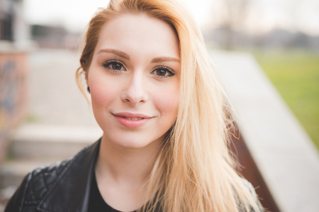young beautiful blonde straight hair woman in the cityの写真素材