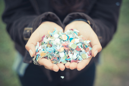 close up of woman hands with confetti outdoorの写真素材