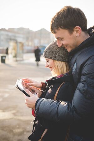 young couple lovers authentic using tablet connected online in the cityの写真素材