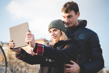 young couple lovers authentic using tablet connected online in the cityの写真素材