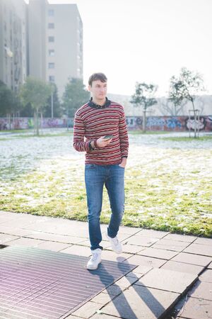 young handsome man using smartphone in the cityの写真素材