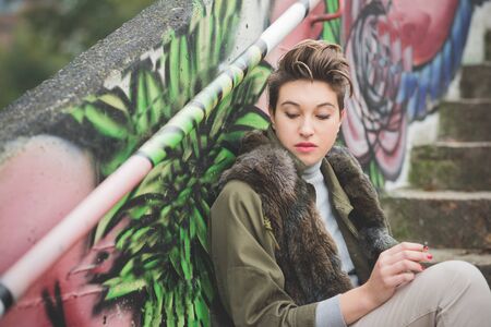 young beautiful short hair hipster woman in townの写真素材