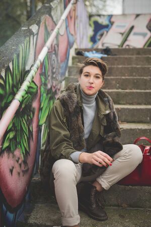 young beautiful short hair hipster woman in townの写真素材