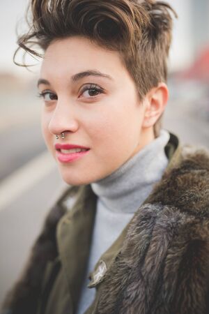 young beautiful short hair hipster woman in townの写真素材