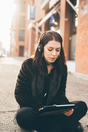 young beautiful woman using tablet in the cityの写真素材